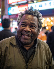 Obraz premium Smiling Senior Black Man on Tokyo Street at Night, Authentic Aging