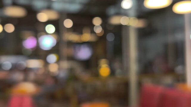A charming bokeh background featuring a night cafe atmosphere. Abstract golden bokeh motion background and urban lights. 4K 60fps. Use for opening videos, intros, outros, and transitions.
