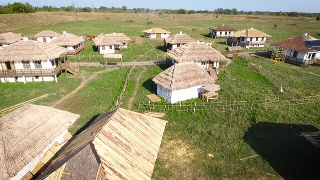 Aerial View of Traditional White Walled Thatched House Village with Construction in Progress. Historical Cossack Settlement Being Built in Southern Russia.