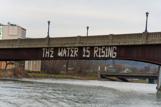 Graffiti on Bridge in Ithaca "The Water Is Rising"