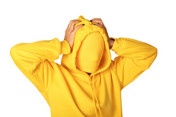Anonymous person in a bright yellow hoodie with covered face, hands on head, isolated on transparent background, concept of identity or anonymity.