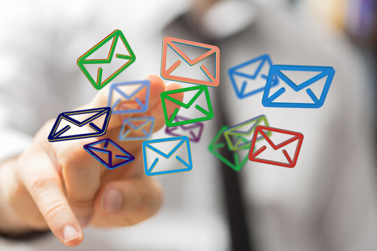 Concept of communication and internet. Hand interacting with floating digital email symbols representing messages and c