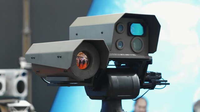 mounted high-tech camera or sensor system, likely used for surveillance, monitoring, or advanced imaging.

Key details:
The device consists of multiple lens units and sensors, including a large cylind