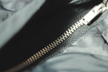A close-up shot of a zipper on a jacket, suitable for use in fashion or lifestyle photography © Fotograf
