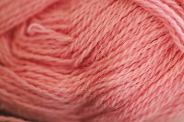 A close-up shot of a bright pink yarn ball, perfect for textiles or crafting projects