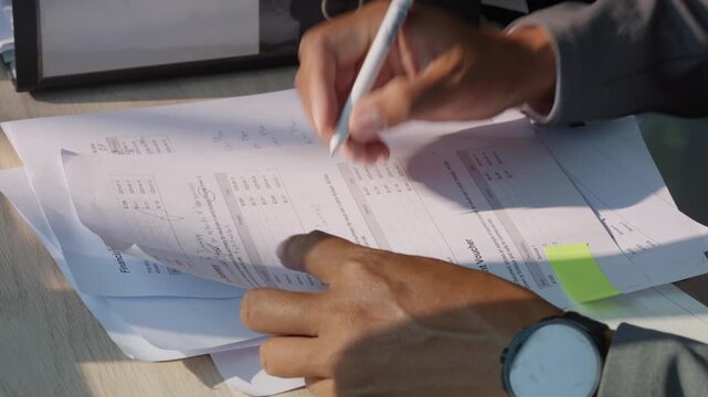 Corporate lawyer reviewing legal documents and business reports at desk, representing analysis, compliance, corporate law, and professional legal workflow concept.