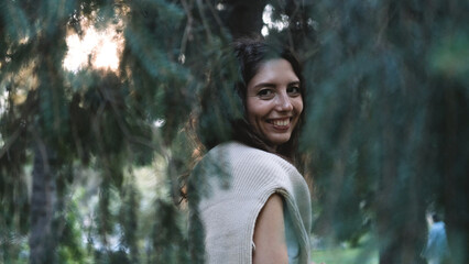 Portrait of a very beautiful young woman in a summer spruce forest at sunset. © ekaterinabyuksel