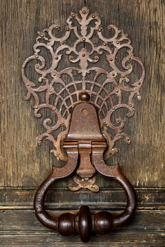 Ornate Vintage Metal Door Handle on Wooden Surface Decorative Detail