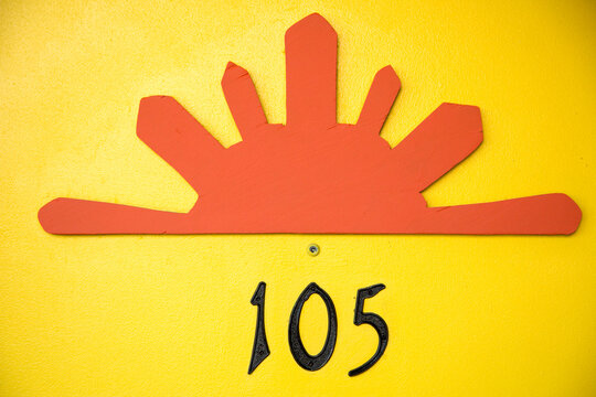 Retro sunburst motel room number 105 detail