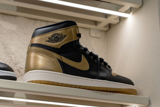 Air Jordan 1 Retro High OG "Black and Gold" sneaker on display shelf at Nike brand store. Minsk, Belarus - December 16, 2025