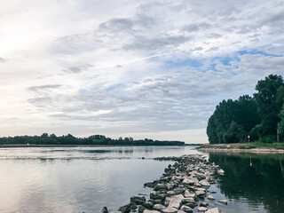 Serene River Landscape Under Cloudy Sky