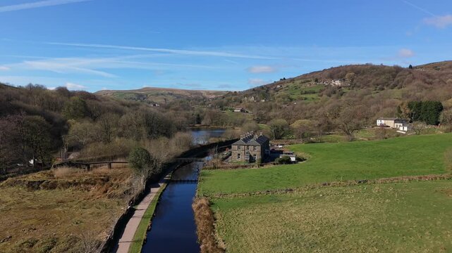 Aerial Drone view of Huddersfield Narrow Canal and Sparth reservoir on a bright Spring morning