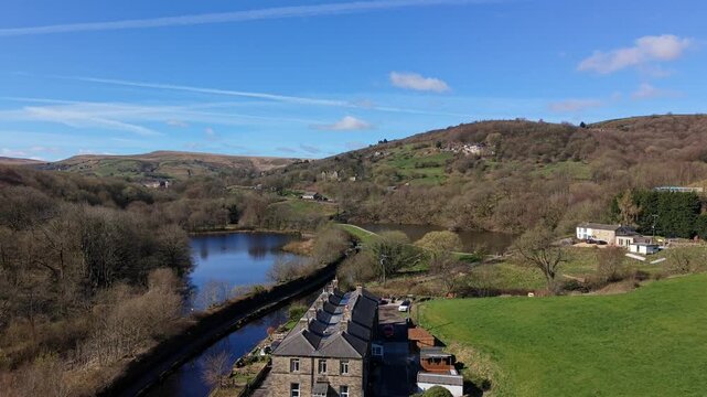 Aerial Drone view of Sparth Reservoir and Huddersfield Narrow Canal on a bright sunny Spring day, Marsden, West Yorkshire 