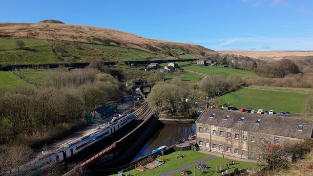 A train entrring a picturesque tunnel in the village of Marsden, West Yorkshire