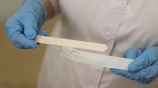 Disposable spatula. ENT doctor. Unpacking medical supplies. Slow motion video. High quality 4k footage
