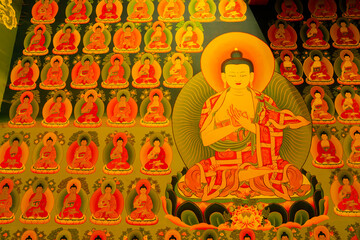 Obraz premium Hemis,Ladakh,India - 05.09.2014 : Thangka painting, traditional Tibetan Buddhist artwork of Shakyamuni Buddha, seated in a lotus posture on a throne, at Hemis Monastery, Himalayan Buddhist monastery.