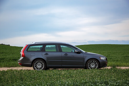 MINSK, Belarus - May 1, 2015. Side view of a Volvo v 50 car on a dirt road against the background of a green field. A Swedish car.
