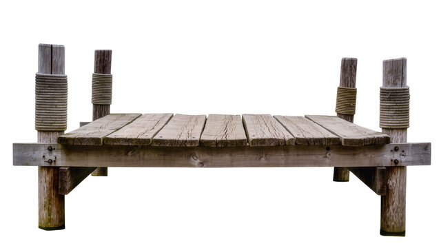 Isolated old wooden pier or small dock on posts wrapped with rope for boats and fishing