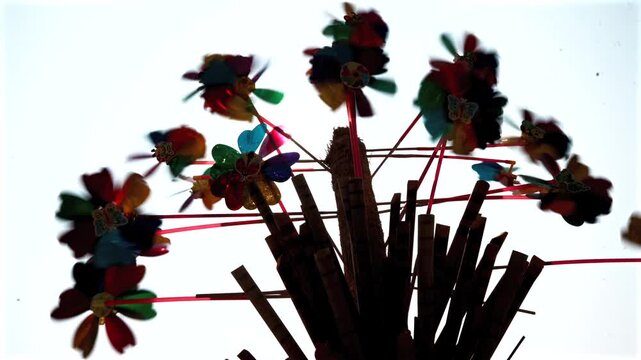 Colourful pinwheels and toys displayed at a street stall during a local fair in India
