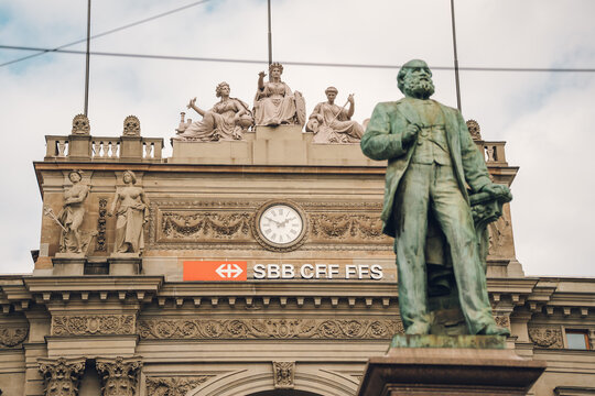 Zurich, Switzerland March 28, 2026: Iconic alfred escher statue standing in front of the historic architectural facade of zurich main station
