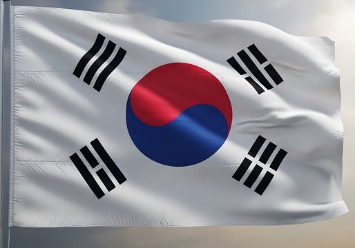 Waving South Korean flag with its iconic Taegeuk symbol and trigrams against a subtly clouded sky