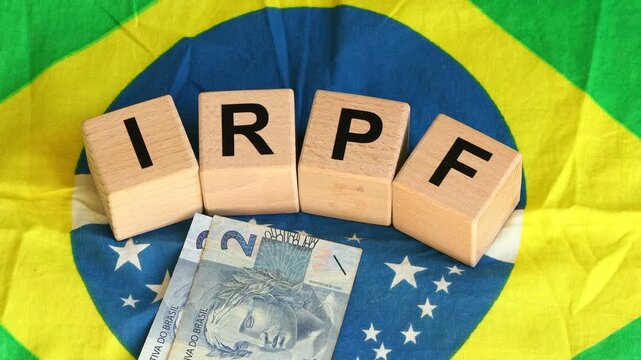 IRPF Brazil. Letters representing the Income Tax of Individuals in Brazil. Financial business concept. The irpf symbol on the background of the Brazilian flag and the conversion of money reais