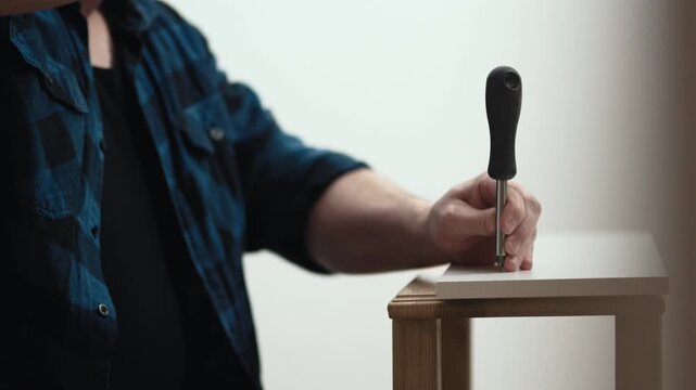 Handyman using hammer to assemble wooden shelf, furniture installation process, high quality 10 bit 4K.