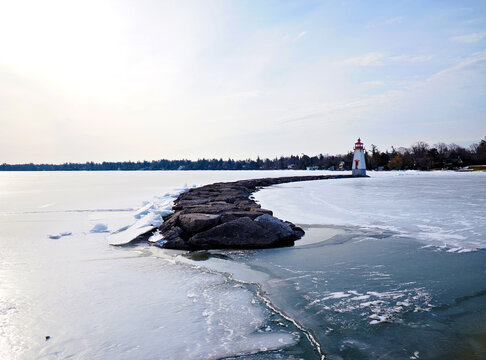 Lighthouse on Frozen Lake Simcoe with Icy Shoreline in Winter, Ontario, Canada