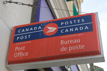 Naklejka premium wall mounted illuminated box projecting sign outside a Canada Post, Post Office on Yonge St, Toronto