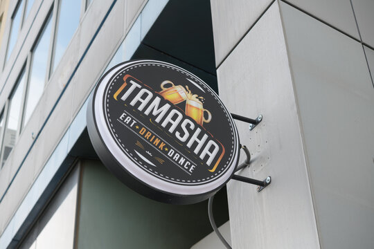 wall mounted round projecting sign of Tamasha, a modern bar and kitchen, Indian restaurant, located at 1835 Yonge St, Toronto
