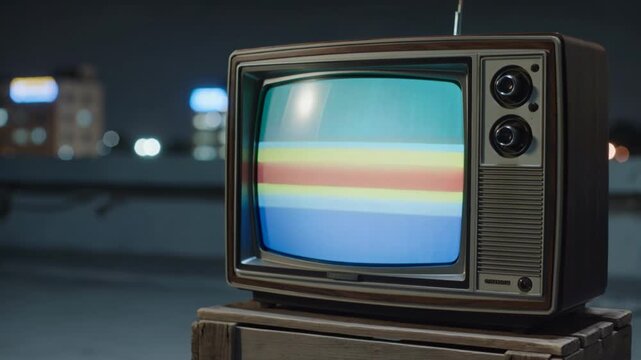 An old-fashioned television set with a colorful signal interference pattern placed on a lonely urban rooftop under a darkening sky, reflecting a sense of nostalgia and obsolete technology