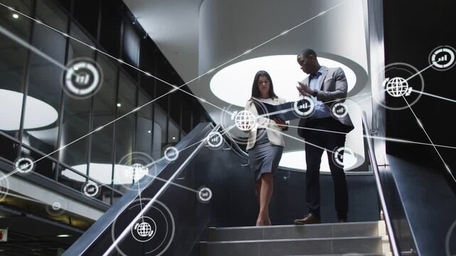 Pair opening blue folder and starting down business stairs, reviewing while network overlay growing