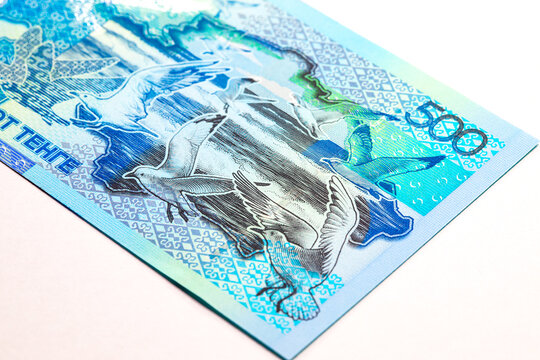 Kazakhstan 500 Tenge banknote featuring the Caspian Sea, flying gulls, and a map outline of Kazakhstan. Kazakhstan's national currency in blue tones.