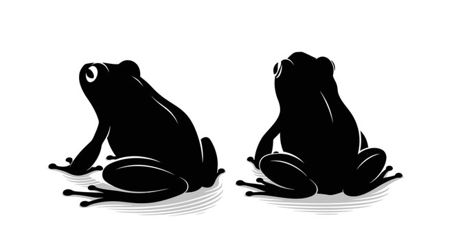 Two Black Frogs Silhouettes Facing Different Directions.
