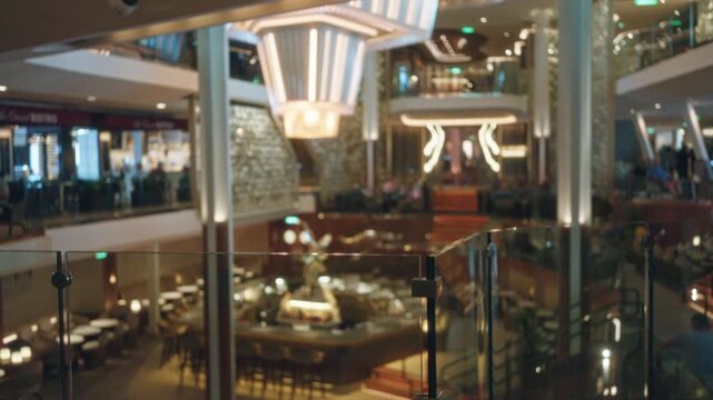 Hotel lobby blurred bokeh interior with soft defocused lights, warm tones and glass railings; background backplate copyspace calm.