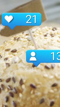 Vertical video: Seeded bun on pick like bubble popping causing counts rising showing patty for food