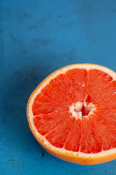Grapefruit cut in half on colorful surface 