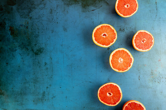 Grapefruit cut in half on colorful surface 