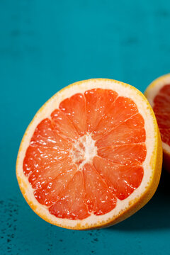 Grapefruit cut in half on colorful surface 
