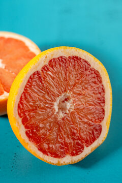 Grapefruit cut in half on colorful surface 