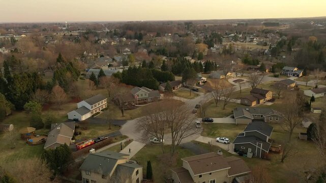 Aerial view of suburban cul de sac neighborhood with residential houses in Wisconsin during spring sunset