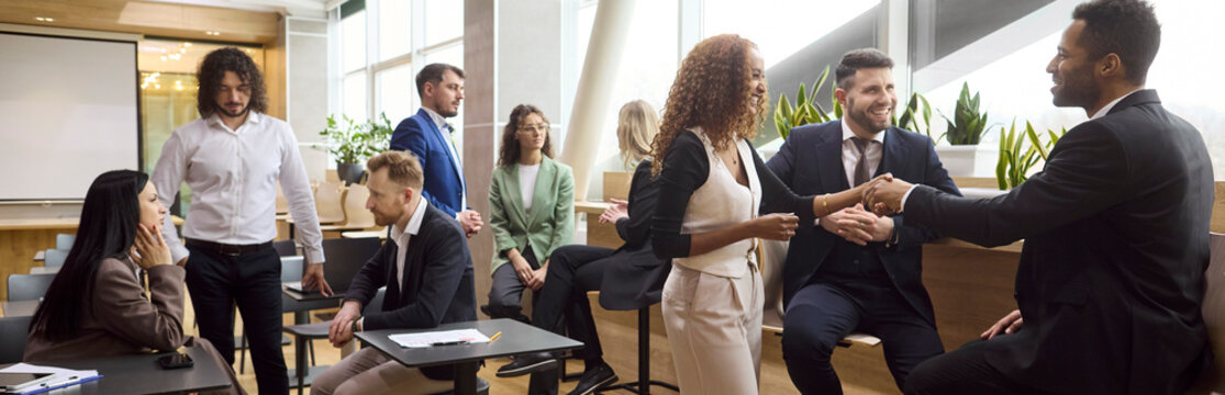 Business handshake colleagues meeting networking team partnership professionals. In a bright modern office diverse coworkers discuss and build trust. Corporate partnership and collaboration concept.