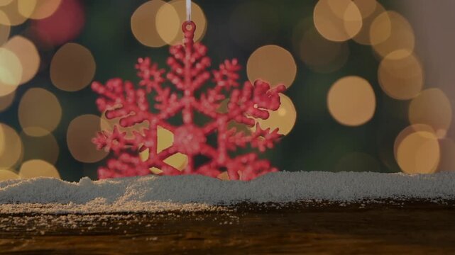 Animation of snow falling over christmas tree and decorations with wooden banner