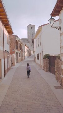 Local tourism in Spain near Madrid in Buitrago de Lozoya. aerial. Honduran latin woman traveler.