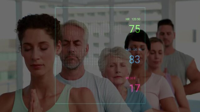 Wellness group standing inside yoga studio, displaying animated vital-sign waveform overlays