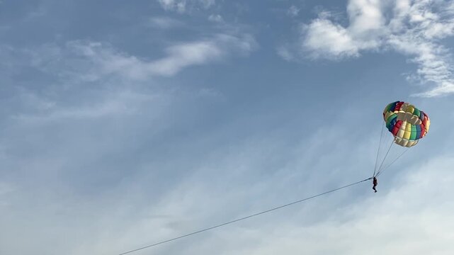 Parasailing over the ocean, slow motion view