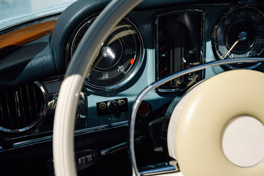 Vintage Car Steering Wheel And Dashboard Close-Up With Classic Speedometer And Chrome Details
