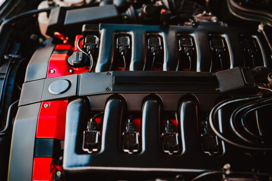 High Performance Car V12 Engine Closeup Showing Intake Manifold, Ignition Coils and Red Engine Bay Accents