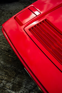 Red Sports Car Hood With Glossy Vents And Close-Up Automotive Design Detail
