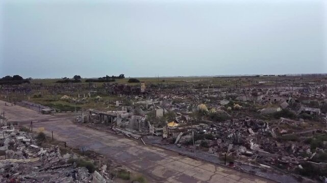 Aerial shot crossing a former street in the city of Villa Epecuen. Only rubble is observed in a devastating and tragic stormy atmosphere.